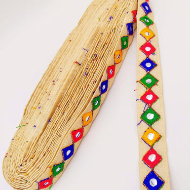 Wholesale Beige Cotton Fabric Mirrored Trim With Embroidery In Yellow, Blue, Red & Green Threads